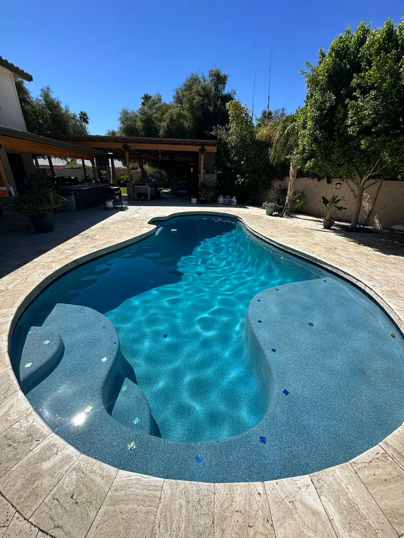 Pool and spa surrounded by mature trees