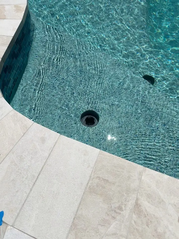New waterline tile and travertine coping